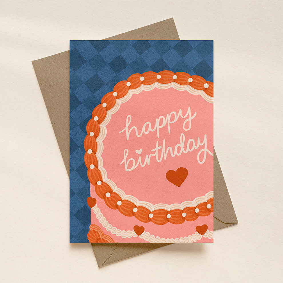 Birthday card with pink cake design and 'happy birthday' text on a blue and brown checkered background