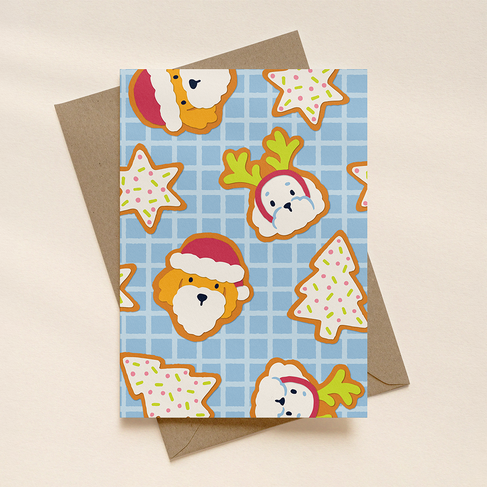Greeting card with Christmas-themed cookies on a blue checkered background