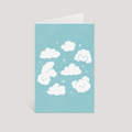 Greeting card with white cloud animal designs on a light blue background