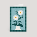 Greeting card with daisy flowers in a vase on a blue and green checkered background