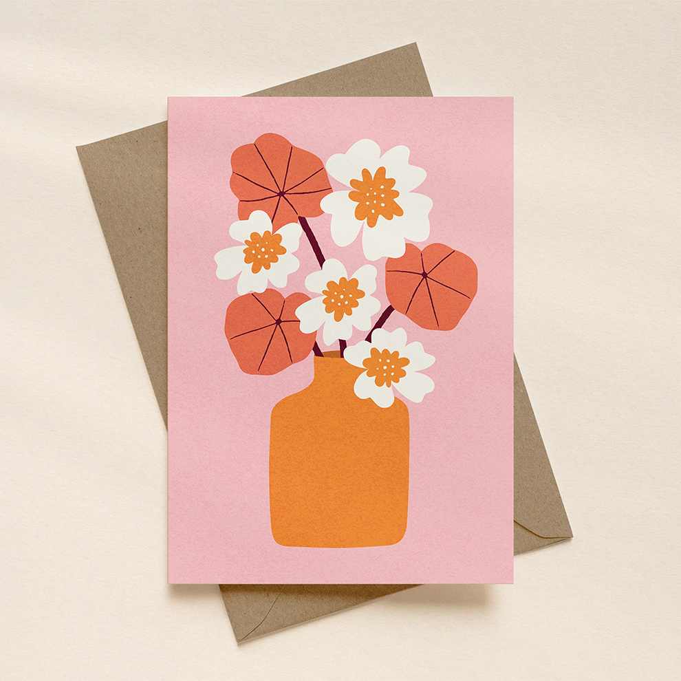 Greeting card with floral design on a pink background, featuring an orange vase and flowers.