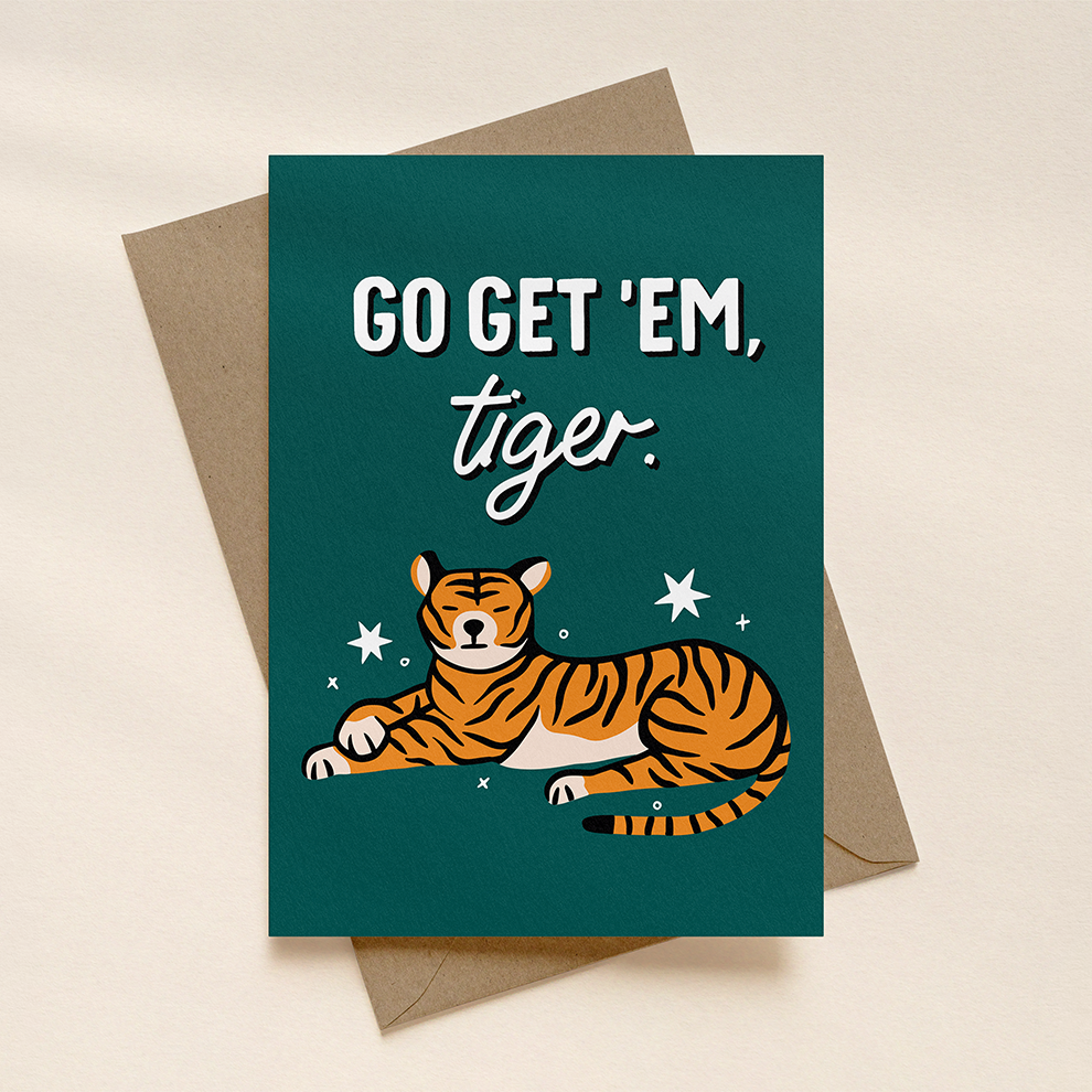 Greeting card with tiger illustration and 'Go Get 'em, tiger.' text on a beige background