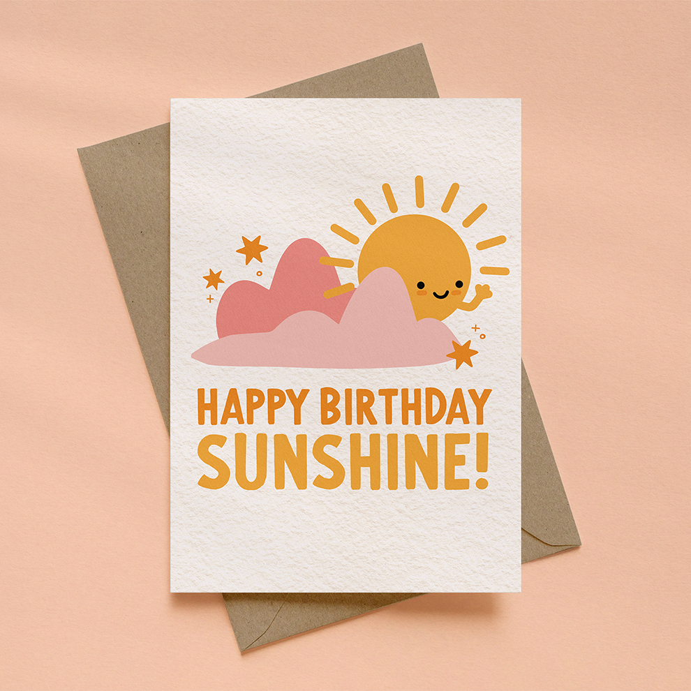 Greeting card with sun and cloud design and 'Happy Birthday Sunshine!' text on a peach background