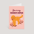 Greeting card with a dog illustration and text 'You're my favourite human' on a pink background