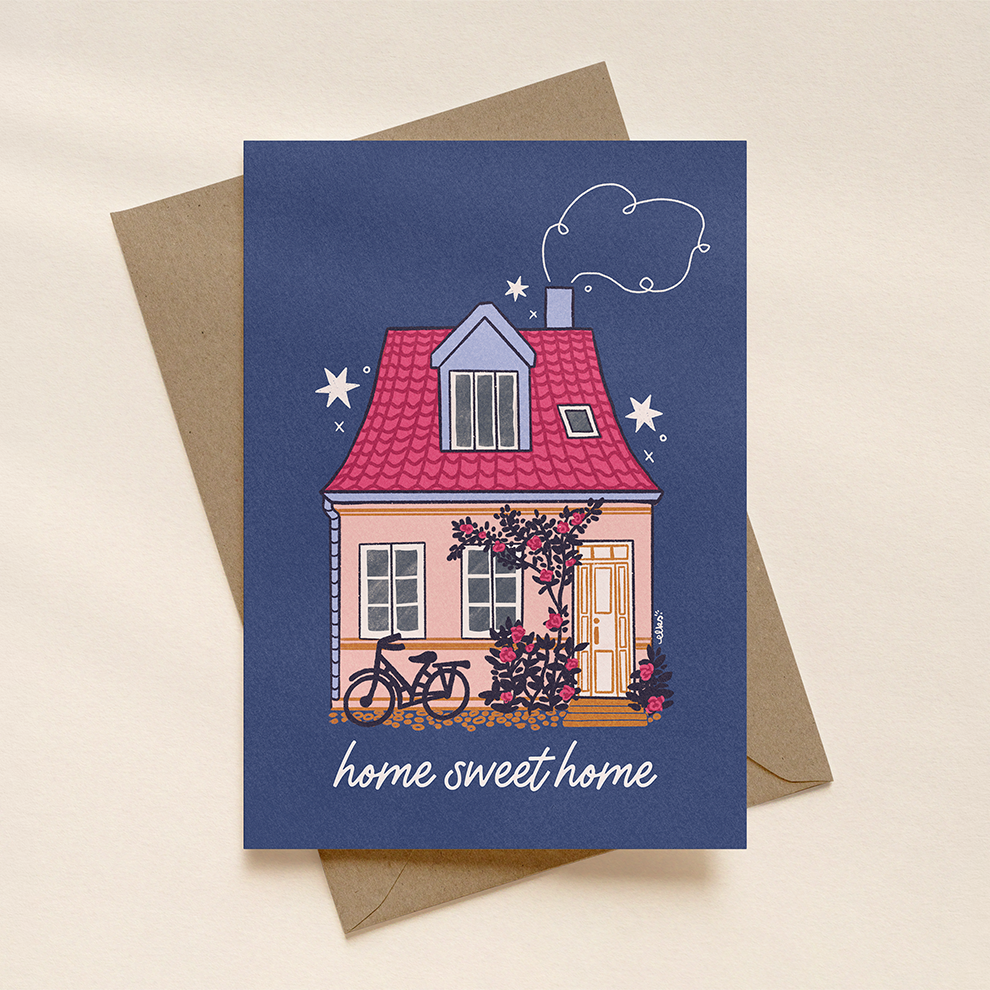 Greeting card with a house illustration and 'home sweet home' text on a blue background, featuring a brown envelope.