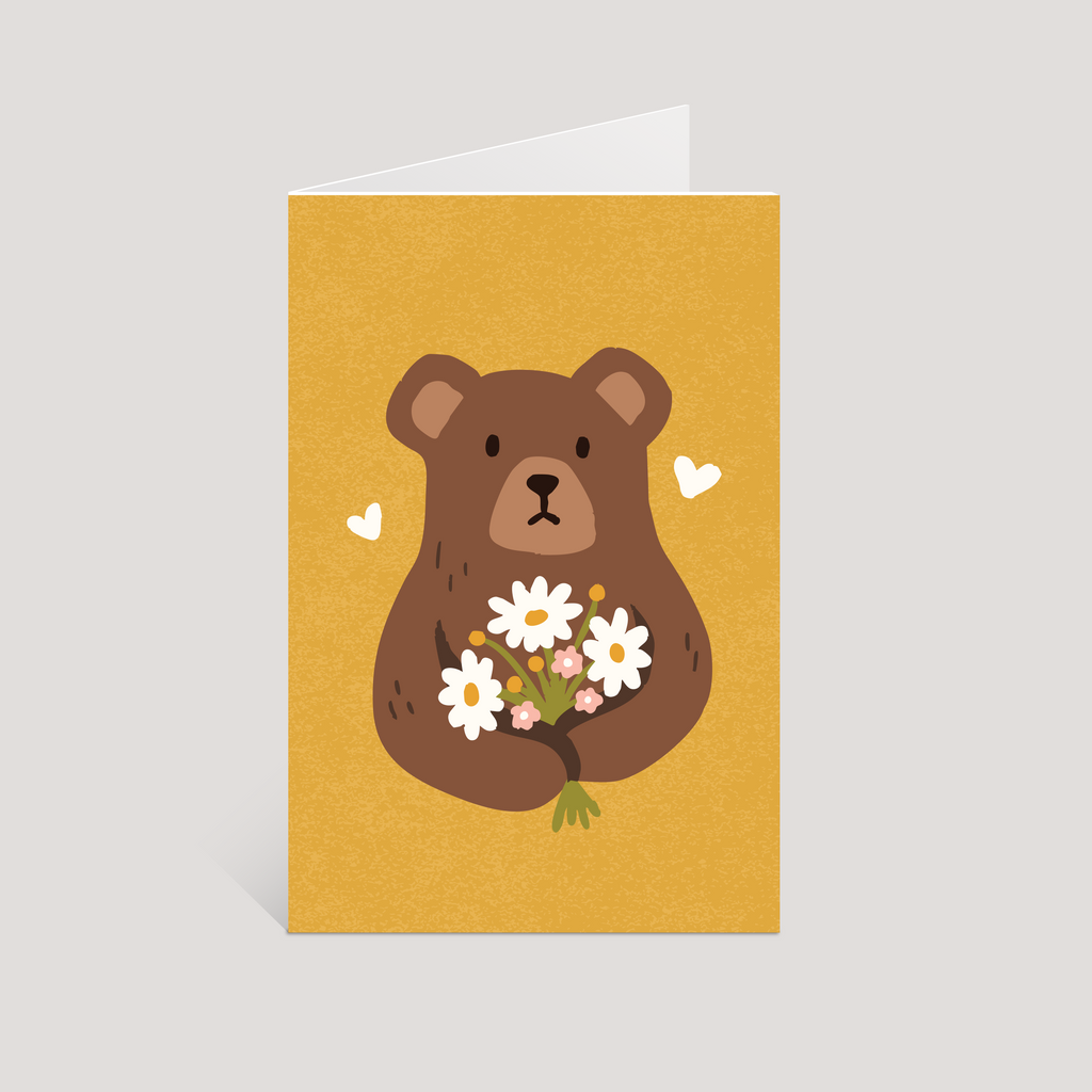 Greeting card with a bear holding flowers on a yellow background