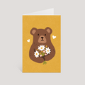 Greeting card with a bear holding flowers on a yellow background