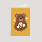 Greeting card with a bear holding flowers on a yellow background