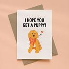 Greeting card with a cartoon dog and "I hope you get a puppy" text on a beige background