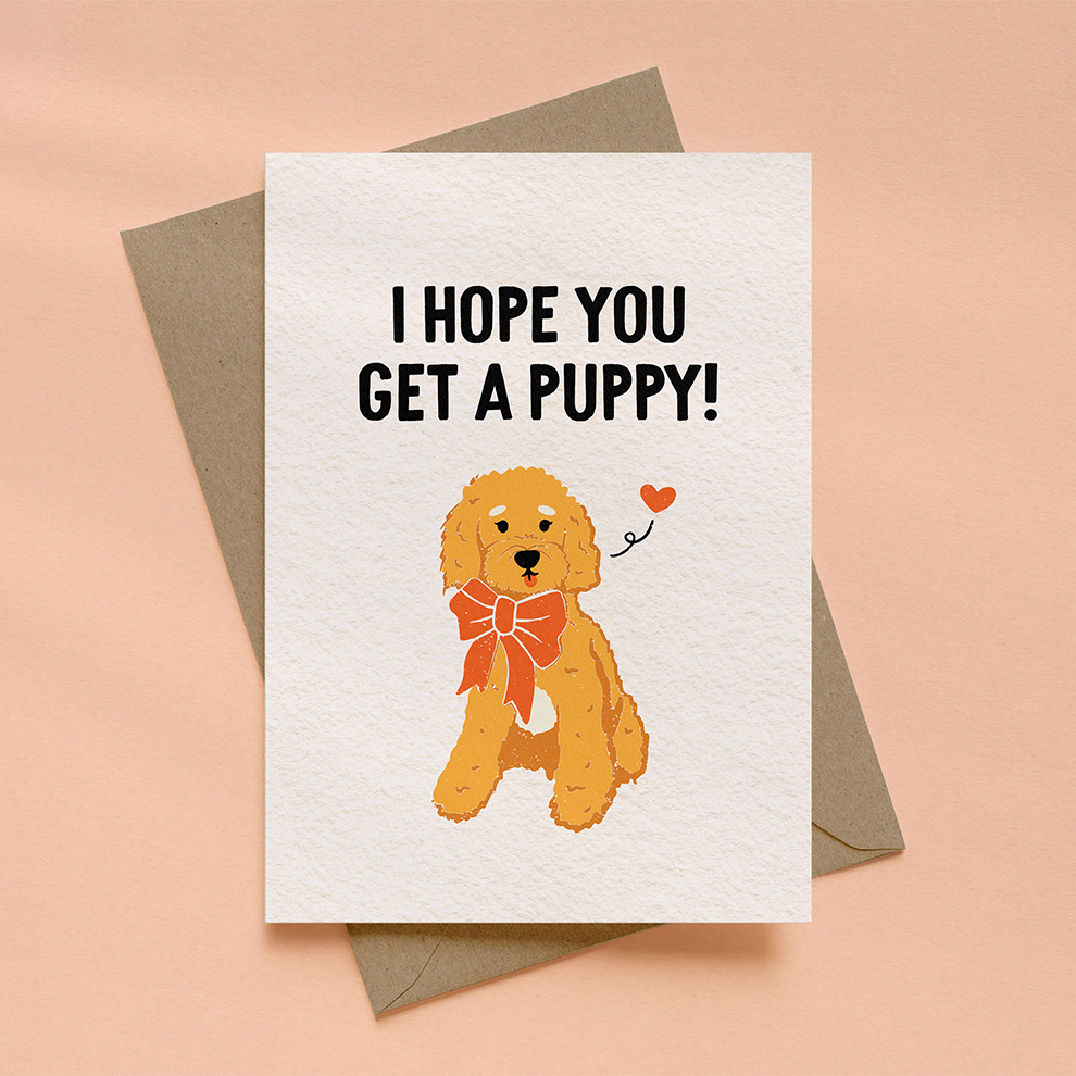 Greeting card with a cartoon dog and "I hope you get a puppy" text on a beige background