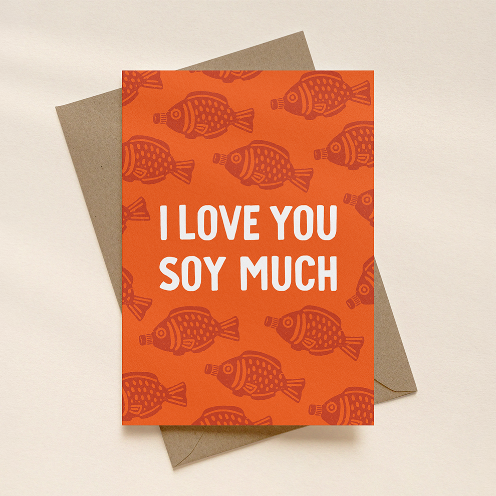 Orange card with soy sauce fish pattern and 'I Love You Soy Much' text on a beige background