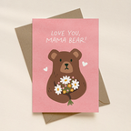 Greeting card with a bear illustration and 'Love You, Mama Bear!' text on a pink background.