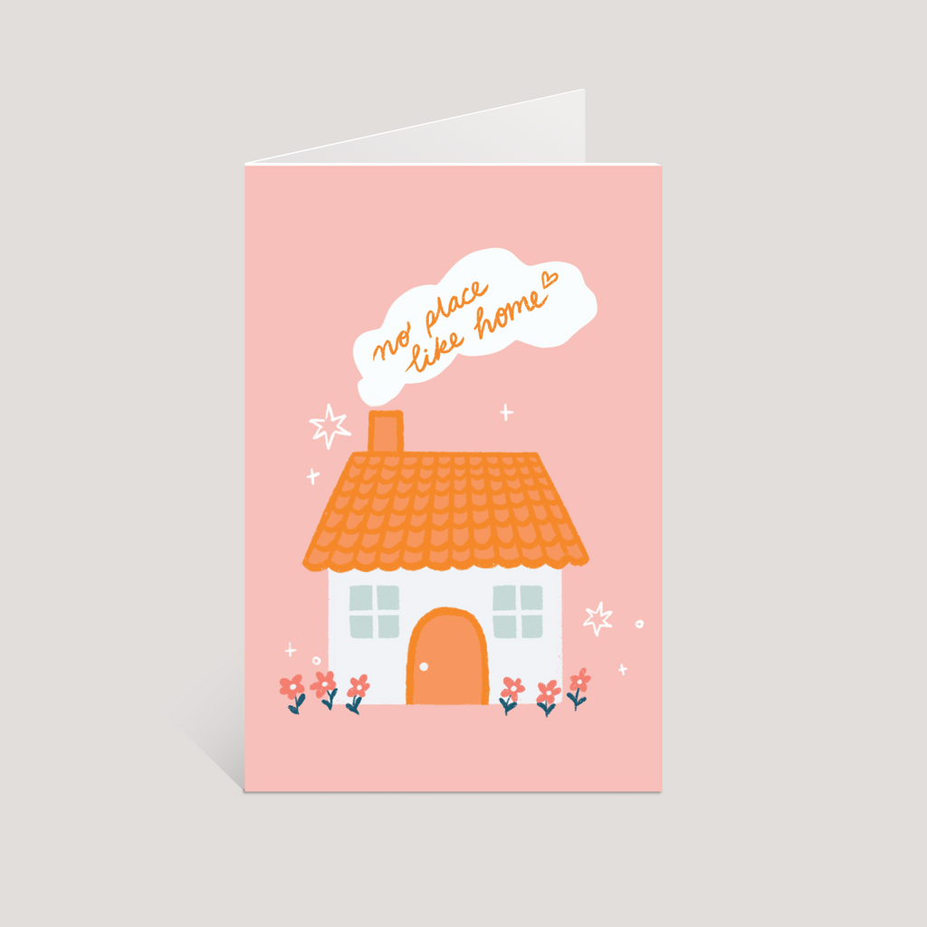 Greeting card with a house illustration and 'no place like home' text on a pink background