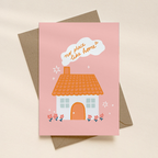 Greeting card with a house illustration and 'no place like home' text on a pink background