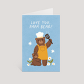 Greeting card with a bear wearing a chef's hat and apron, holding a spatula, on a blue background with 'Love You, Papa Bear!' text.