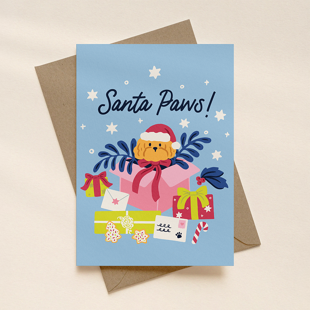 Christmas card with a dog wearing a Santa hat and presents on a blue background