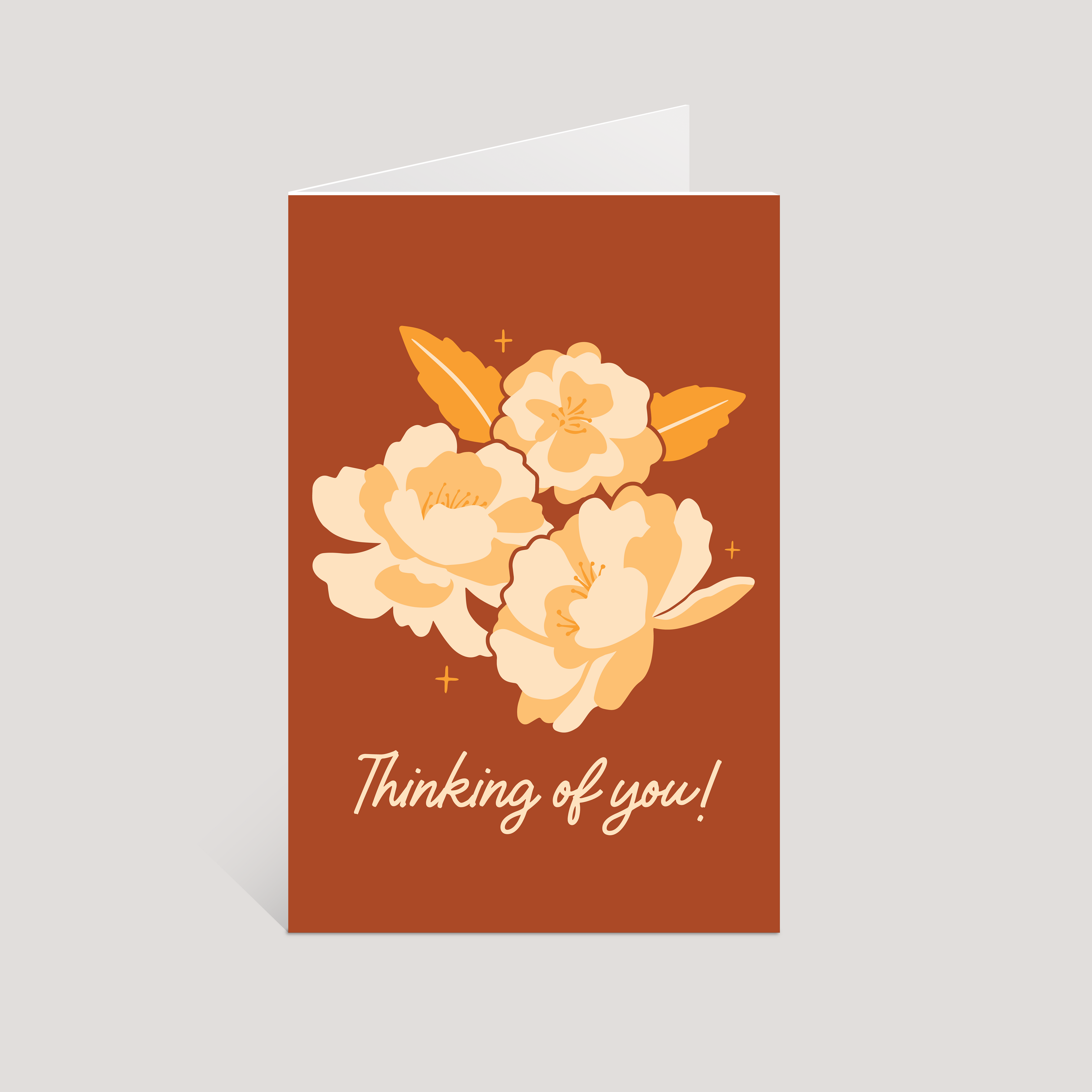 Greeting card with floral design and 'Thinking of you!' text on a brown background