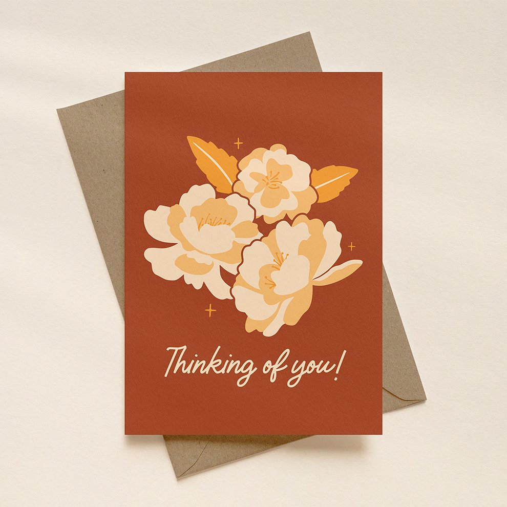 Greeting card with floral design and 'Thinking of you!' text on a beige background