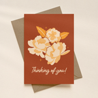 Greeting card with floral design and 'Thinking of you!' text on a beige background