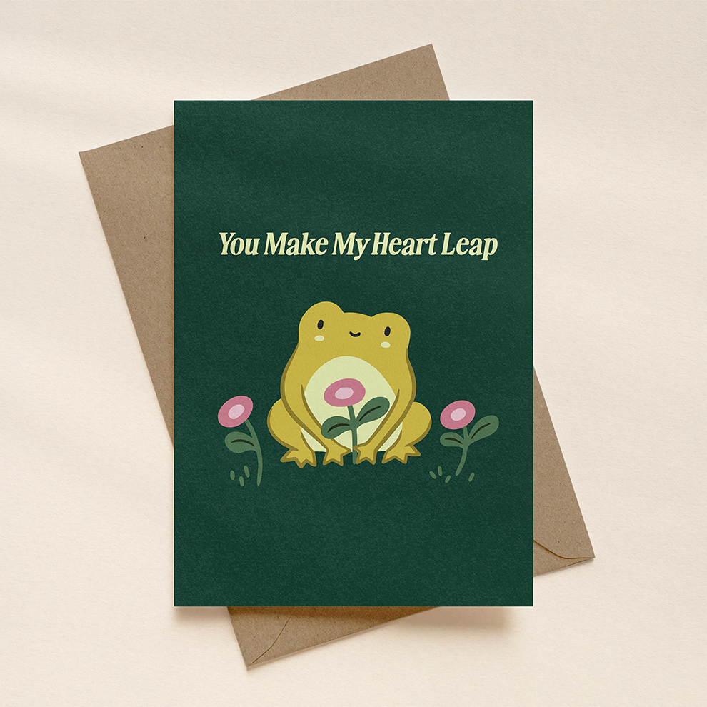 Greeting card with a frog illustration and text 'You Make My Heart Leap' on a beige background